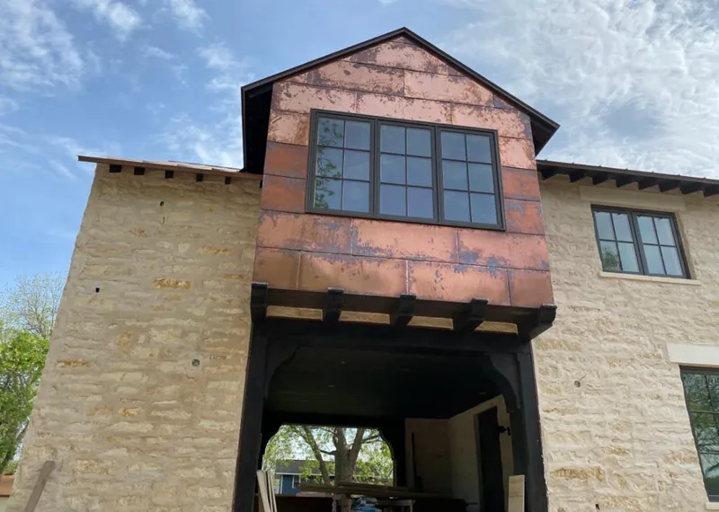 Copper metal panel facade on a stone building for Skylight Installation in Easttown