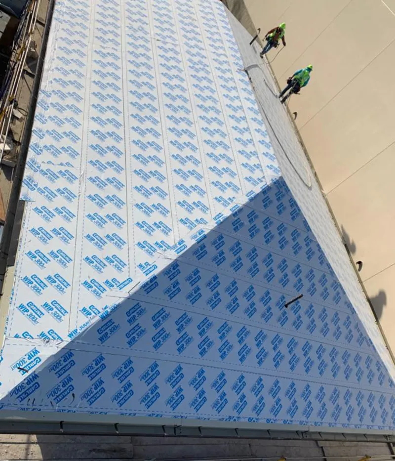 Professional roofers installing underlayment on a metal roof in Easttown